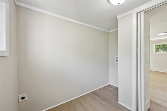 unfurnished room with baseboards, wood finished floors, and crown molding