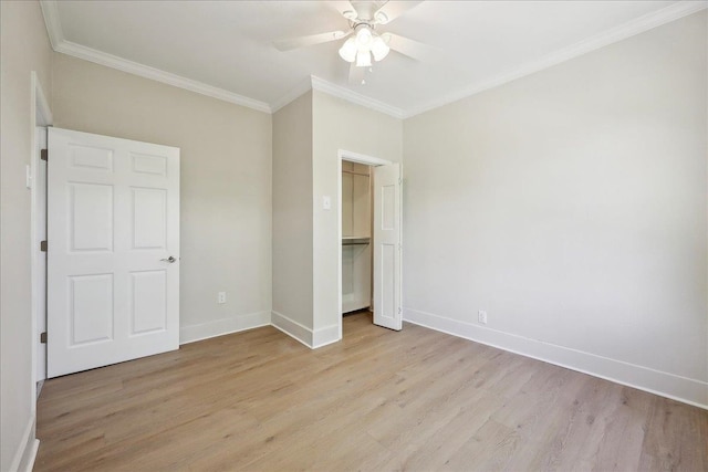 unfurnished bedroom with ornamental molding, a ceiling fan, light wood-style flooring, and baseboards