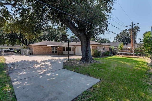 single story home featuring a front yard and a garage