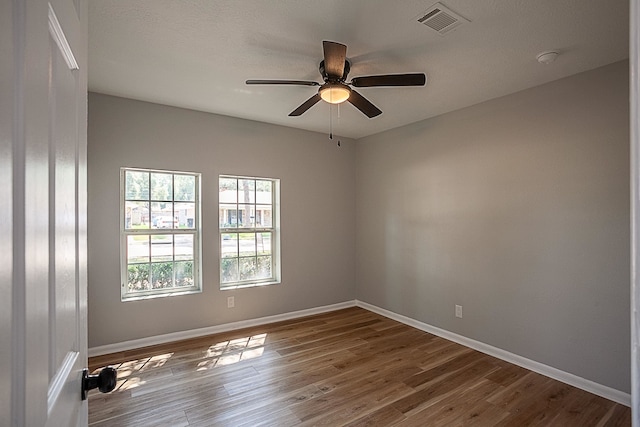 spare room with ceiling fan and hardwood / wood-style floors