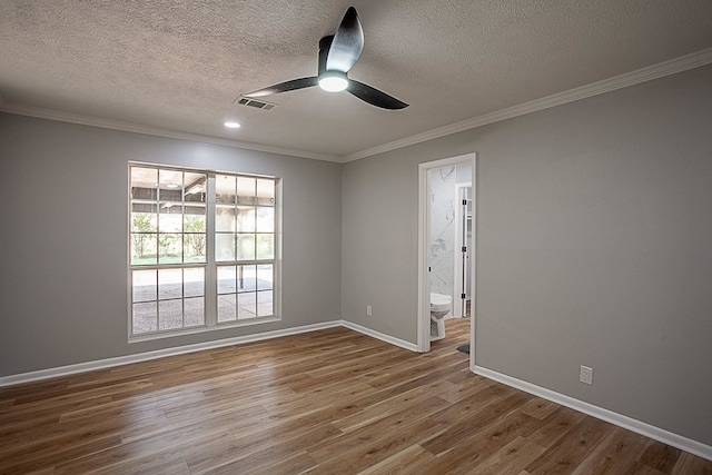 unfurnished room with crown molding, wood-type flooring, and a textured ceiling