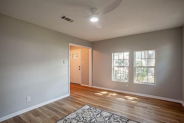 spare room featuring ceiling fan and light hardwood / wood-style flooring