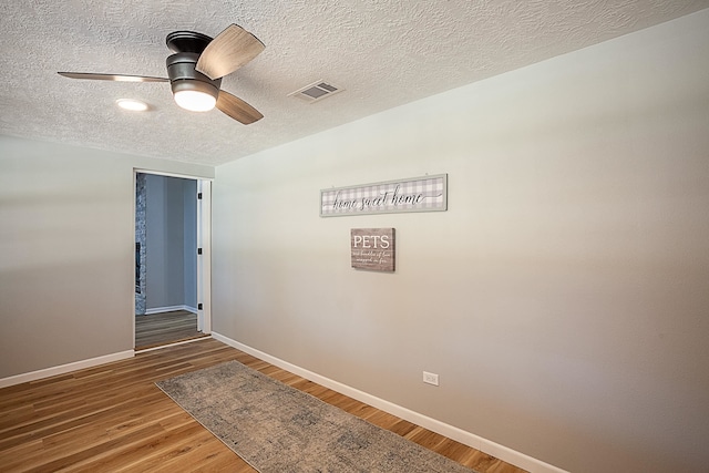 interior space with wood-type flooring and a textured ceiling