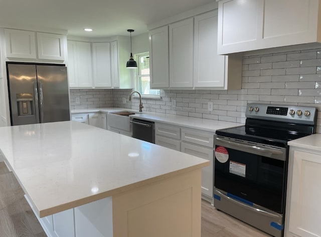 kitchen featuring white cabinets, a kitchen island, and appliances with stainless steel finishes