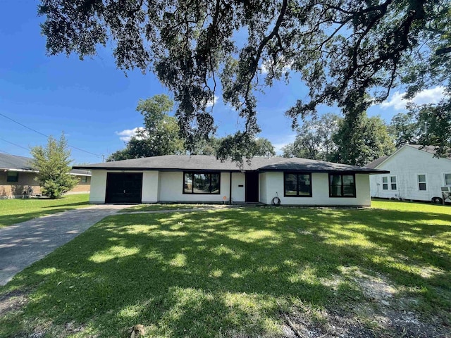 ranch-style home with a front yard and a garage