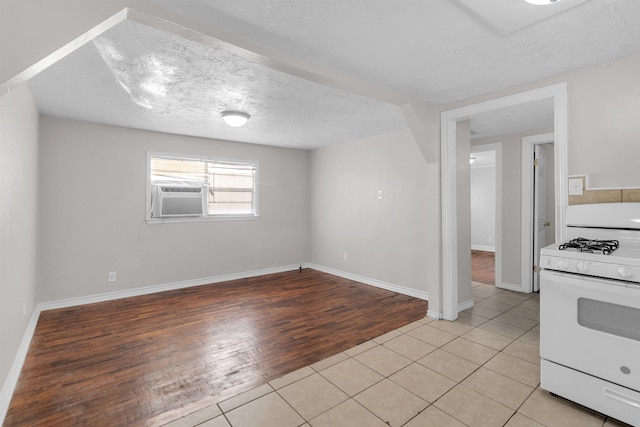 tiled empty room with cooling unit and a textured ceiling