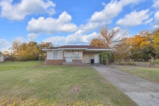 view of front facade with a front yard and a carport