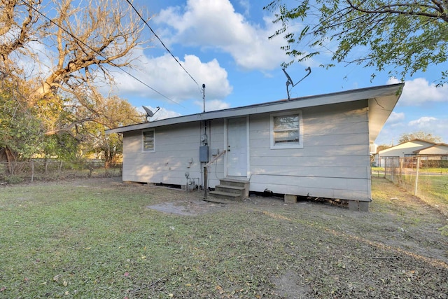 rear view of property with a yard