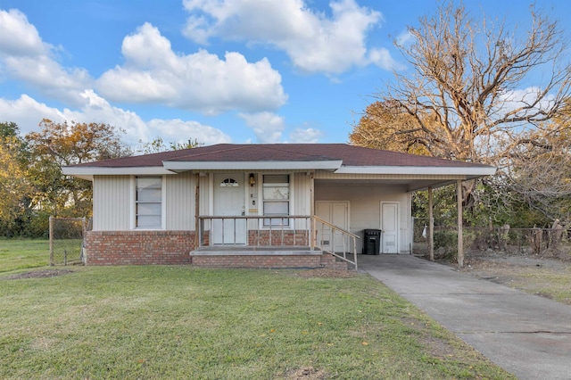 view of front of house with a front lawn and a carport