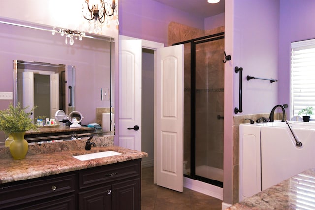 full bathroom featuring tile patterned flooring, a shower stall, a bathing tub, a notable chandelier, and vanity