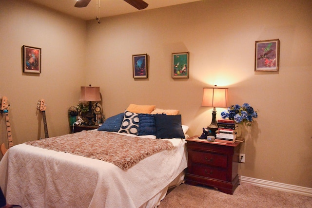 carpeted bedroom featuring a ceiling fan and baseboards