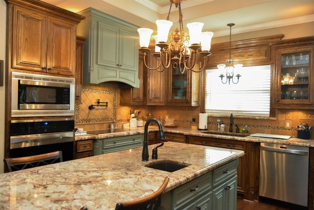 kitchen featuring ornamental molding, stainless steel appliances, an inviting chandelier, and a sink