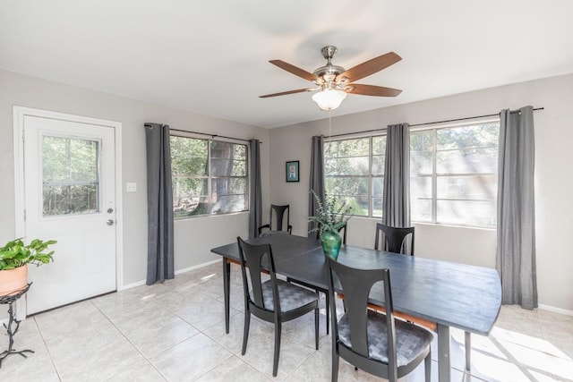 dining room with light tile patterned floors, baseboards, and ceiling fan