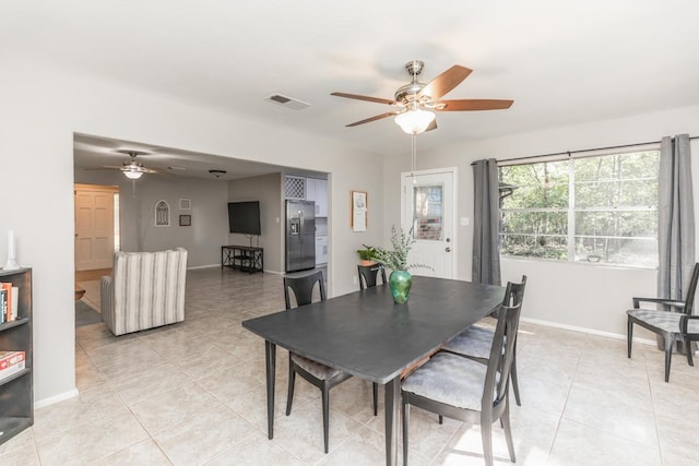 dining space featuring a ceiling fan, light tile patterned flooring, baseboards, and visible vents