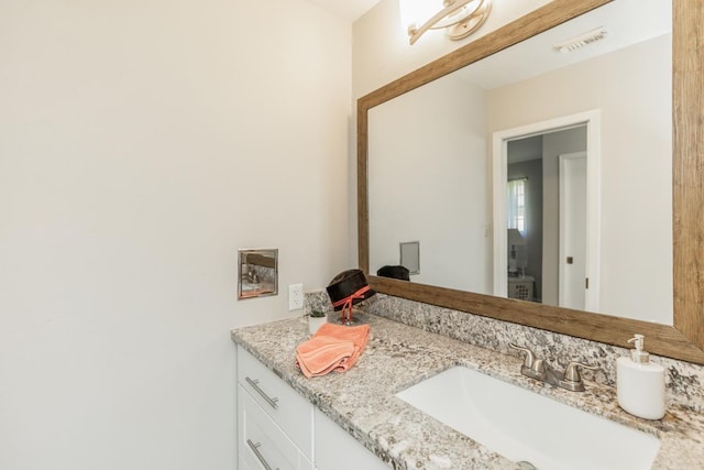 bathroom with vanity and visible vents
