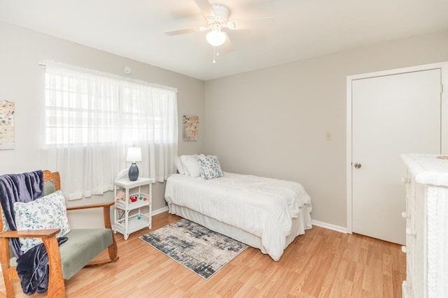 bedroom featuring baseboards, ceiling fan, and wood finished floors