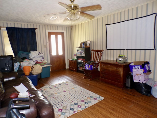 3100 Boyd Ave, Groves, TX 77619 - living area featuring wood-type flooring, wallpapered walls, and ceiling fan