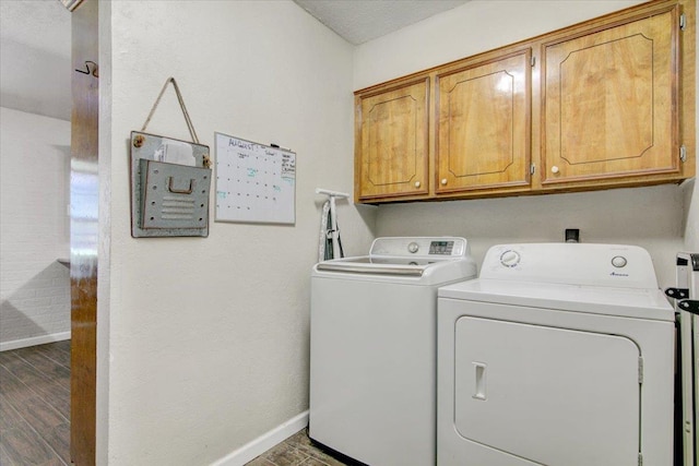 washroom featuring separate washer and dryer and cabinets