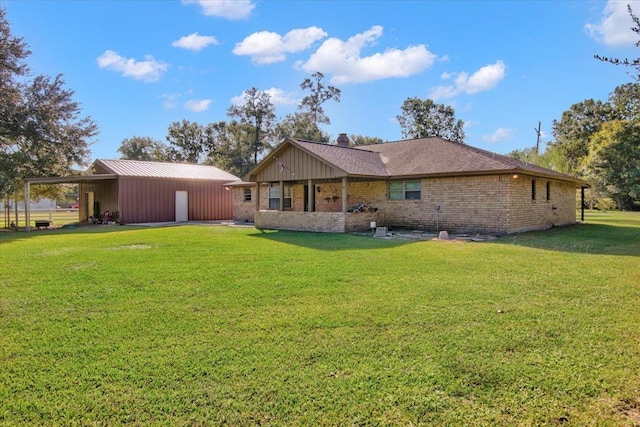 rear view of property featuring a lawn