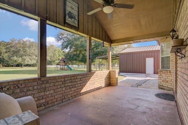 view of patio / terrace featuring a playground, a shed, and ceiling fan