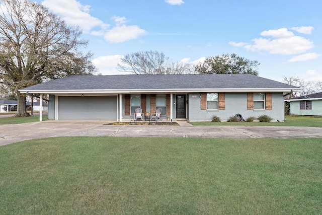 ranch-style home featuring a garage, covered porch, and a front yard