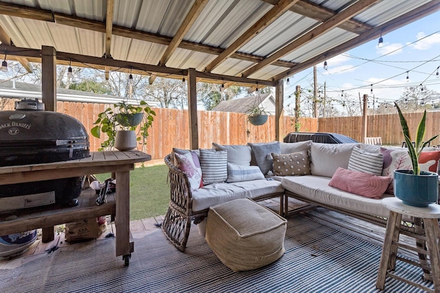 deck with a grill and an outdoor hangout area