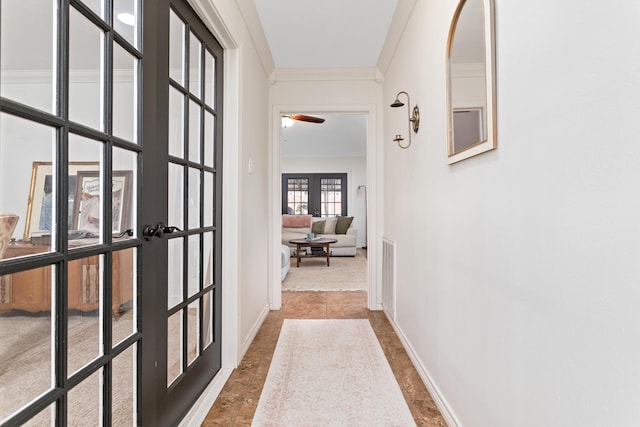 corridor with crown molding and french doors