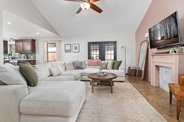 living room featuring sink, vaulted ceiling, french doors, and ceiling fan