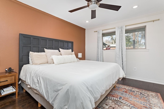 bedroom featuring dark wood-type flooring, ornamental molding, and ceiling fan