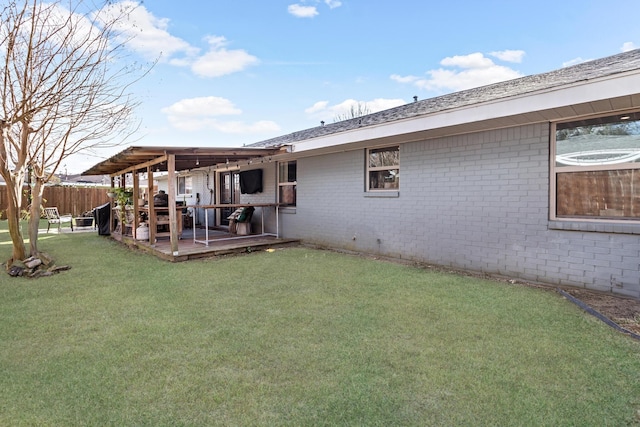 rear view of property with a lawn