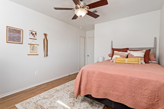 bedroom featuring hardwood / wood-style flooring and ceiling fan