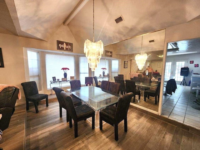 dining room with french doors, vaulted ceiling with beams, and a notable chandelier