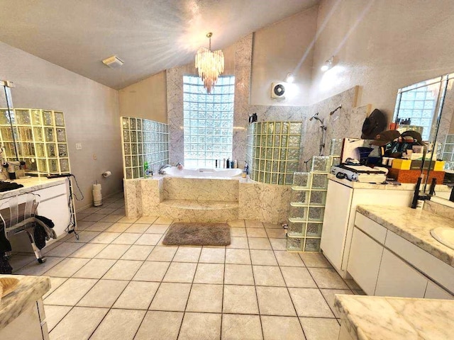 bathroom featuring tile patterned floors, a chandelier, vaulted ceiling, shower with separate bathtub, and vanity