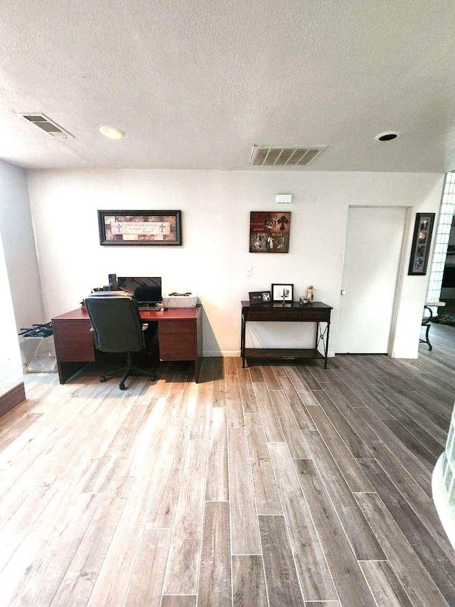 office featuring a textured ceiling and hardwood / wood-style flooring