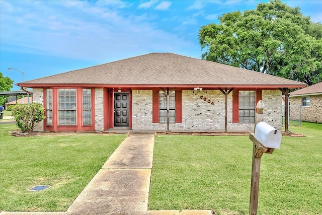 7804 Spring Meadow Ln, Port Arthur, TX 77642 - view of front of home featuring a shingled roof and a front lawn