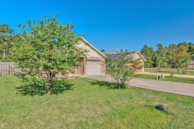 6640 Palace Dr, Lumberton, TX 77657 - obstructed view of property featuring a front yard, fence, brick siding, an attached garage, and concrete driveway