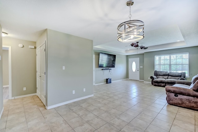6640 Palace Dr, Lumberton, TX 77657 - living area featuring baseboards, a raised ceiling, an inviting chandelier, and light tile patterned flooring