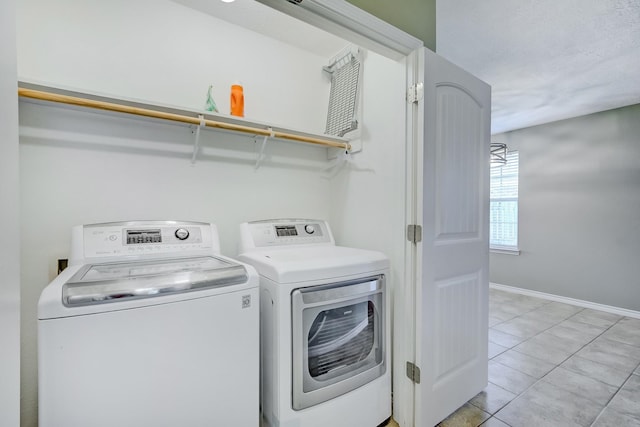 6640 Palace Dr, Lumberton, TX 77657 - clothes washing area featuring washer and clothes dryer, laundry area, baseboards, and light tile patterned flooring