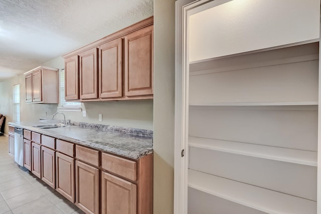 6640 Palace Dr, Lumberton, TX 77657 - kitchen featuring stainless steel dishwasher, light tile patterned floors, and a sink