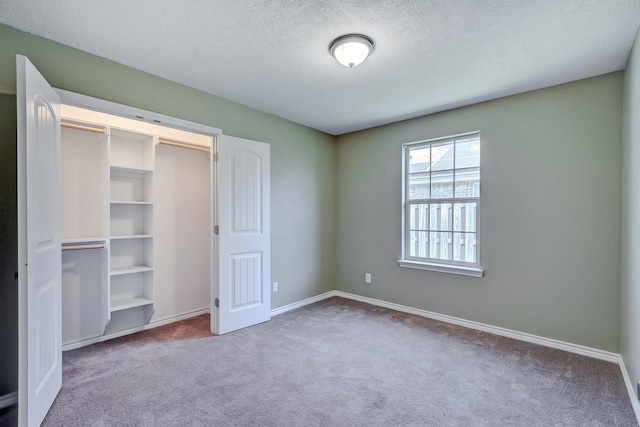 6640 Palace Dr, Lumberton, TX 77657 - unfurnished bedroom with carpet floors, baseboards, and a textured ceiling