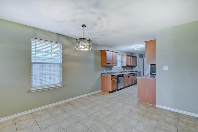 6640 Palace Dr, Lumberton, TX 77657 - kitchen with brown cabinetry, a chandelier, stainless steel dishwasher, and baseboards