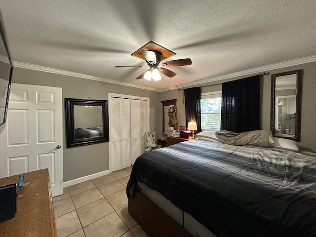1009 Arthur St, Bridge City, TX 77611 - bedroom featuring light tile patterned floors, ornamental molding, a closet, baseboards, and a ceiling fan