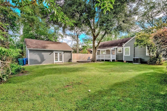 view of yard featuring french doors and central AC