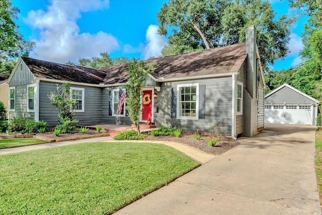 single story home featuring an outbuilding, a front lawn, and a garage