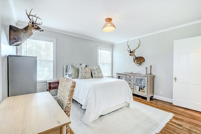 bedroom with hardwood / wood-style flooring and ornamental molding