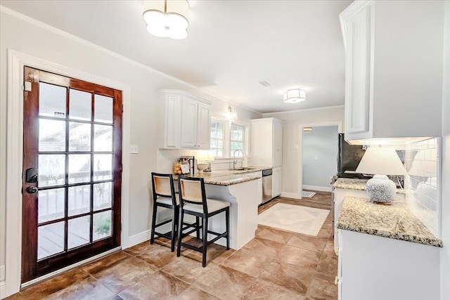 kitchen featuring dishwasher, white cabinetry, light stone countertops, and sink