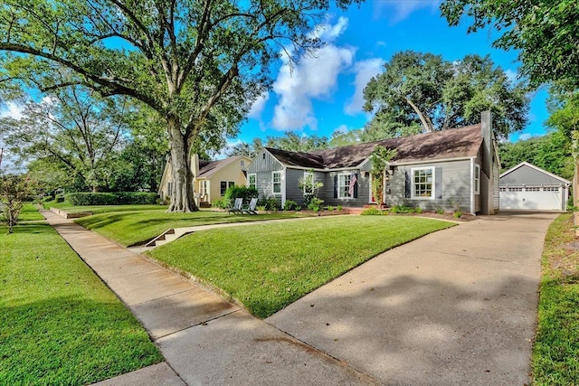 ranch-style home featuring an outbuilding and a front lawn