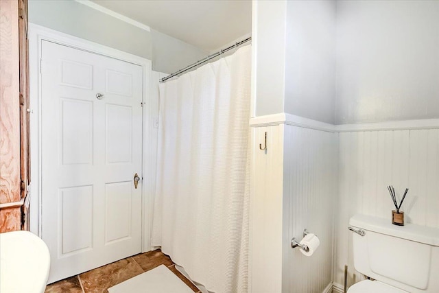 bathroom featuring tile patterned flooring and toilet