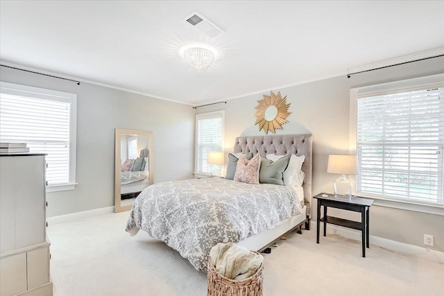 carpeted bedroom with multiple windows and crown molding