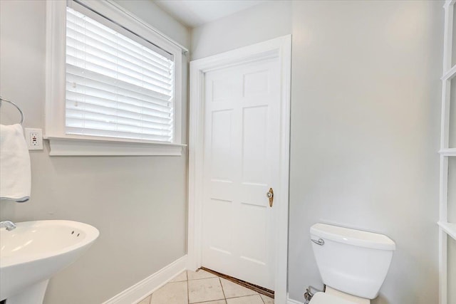 bathroom with tile patterned flooring, toilet, and sink